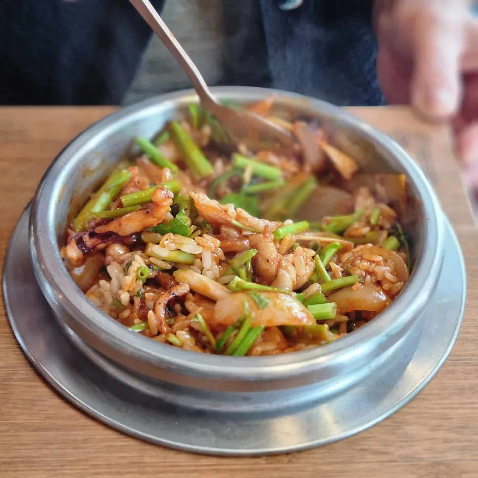 Close-up of pork jowl topped with minari