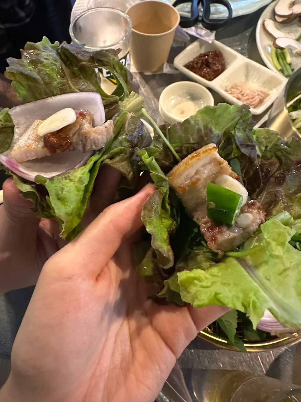 Big pieces of kimchi grilling alongside the pork belly
