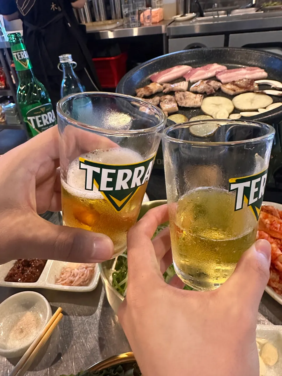 A glass of somaek enjoyed with the pork belly
