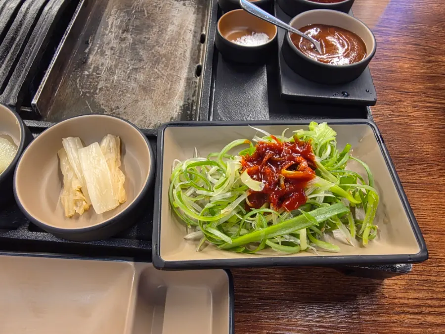 Plate of shredded scallion served with the meat