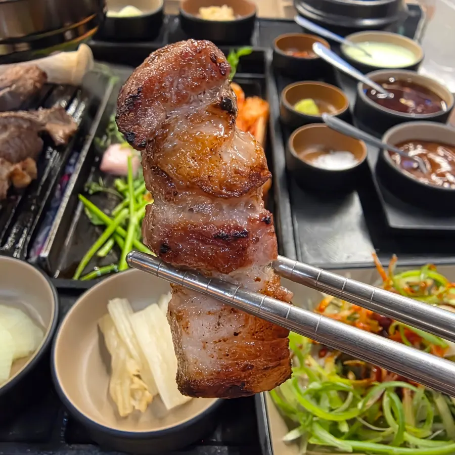 Meat and sauces arranged on a small plate