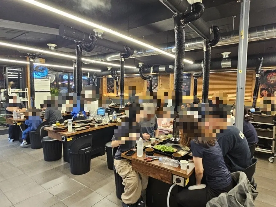 Spacious interior of Donpu The Grill with tables