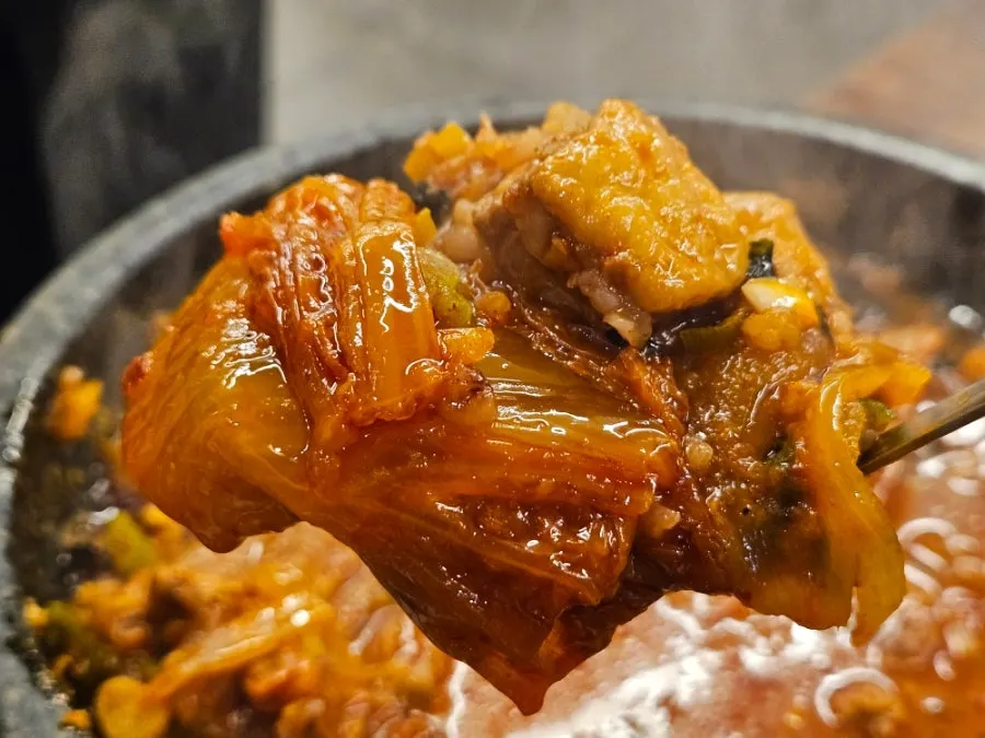 Close-up of stone-pot kimchi rice with meat