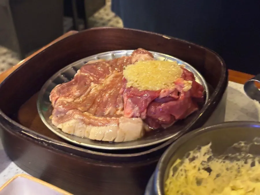 Table spread with multiple cuts of black pork in the Arangjoeul Set