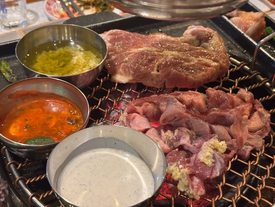 Marinated meat and black pork continuing to grill