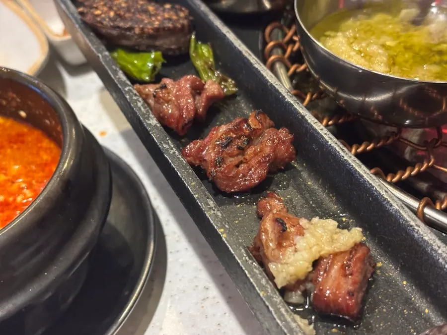 A bite of fully cooked black pork and sundae