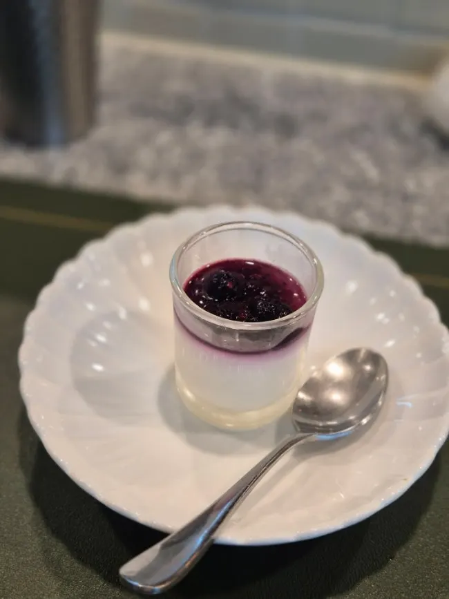 Milk pudding topped with blueberry sauce