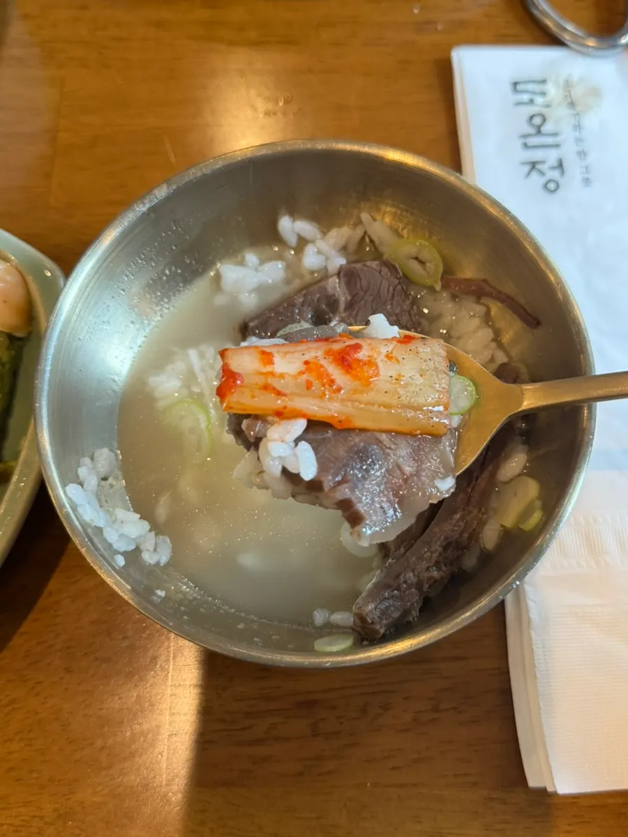 Kimchi served alongside the clear hanwoo gomtang with suji