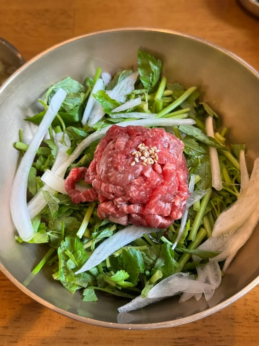Clear hanwoo gomtang with suji served in a brass bowl
