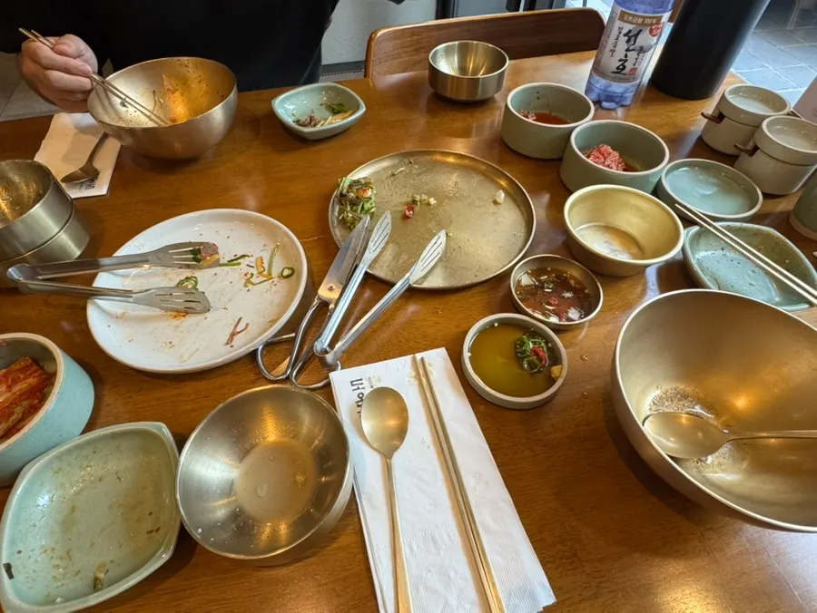 Full table with gomtang, yukhoe bibimbap, minari pancake, and makgeolli