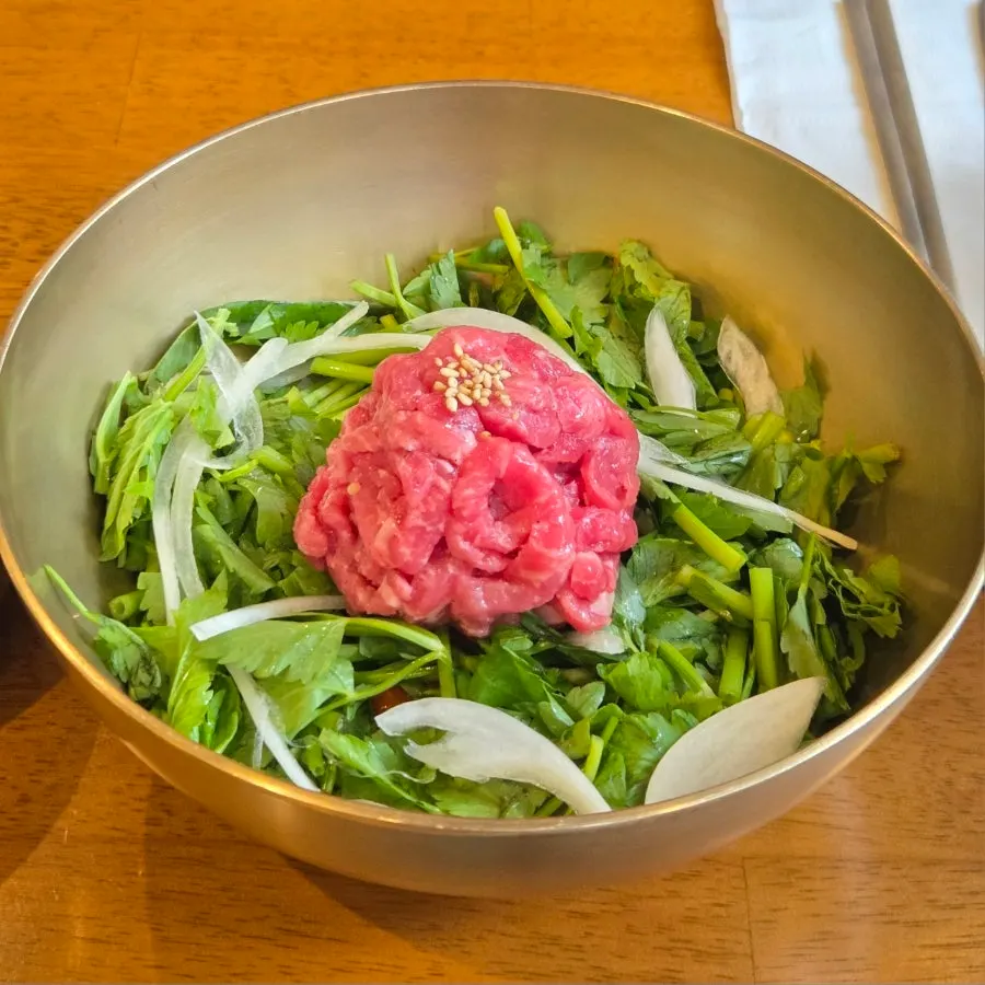Full table spread of yukhoe bibimbap and gomtang at Doonjeong