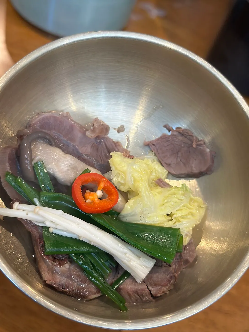 Clear hanwoo jeongol broth coming to a boil