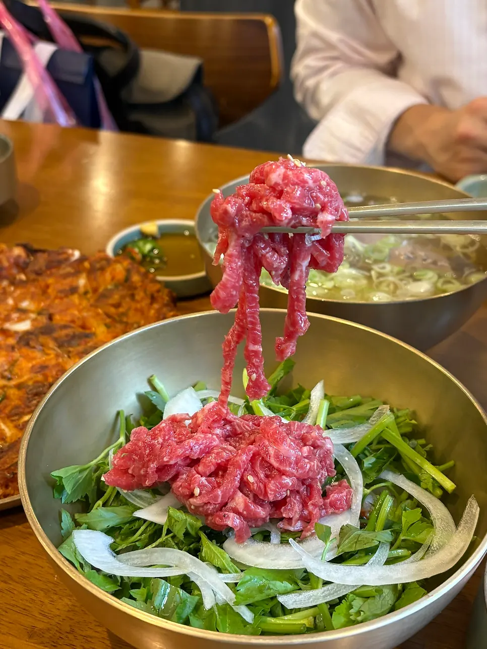 Gomtang broth served alongside the yukhoe bibimbap