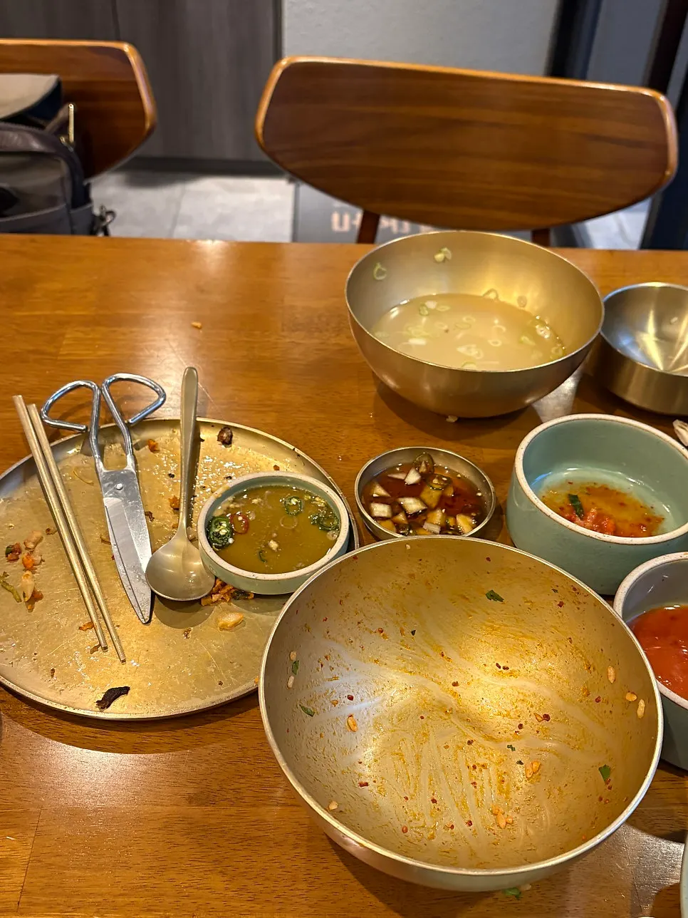 Table spread of yukhoe bibimbap, sujigomtang, and meat kimchi pancake