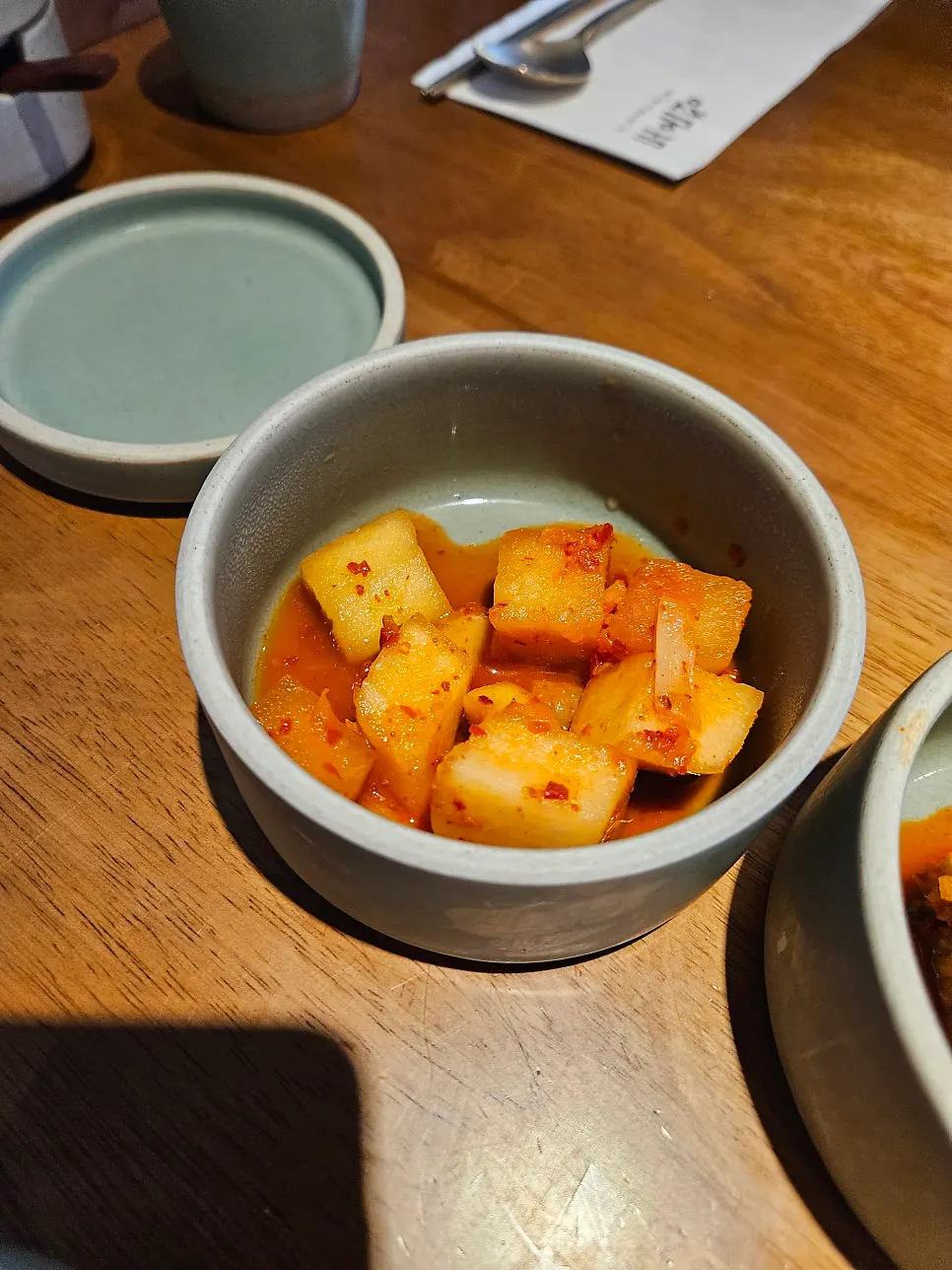 Neatly set tableware and side dishes at Doonjeong