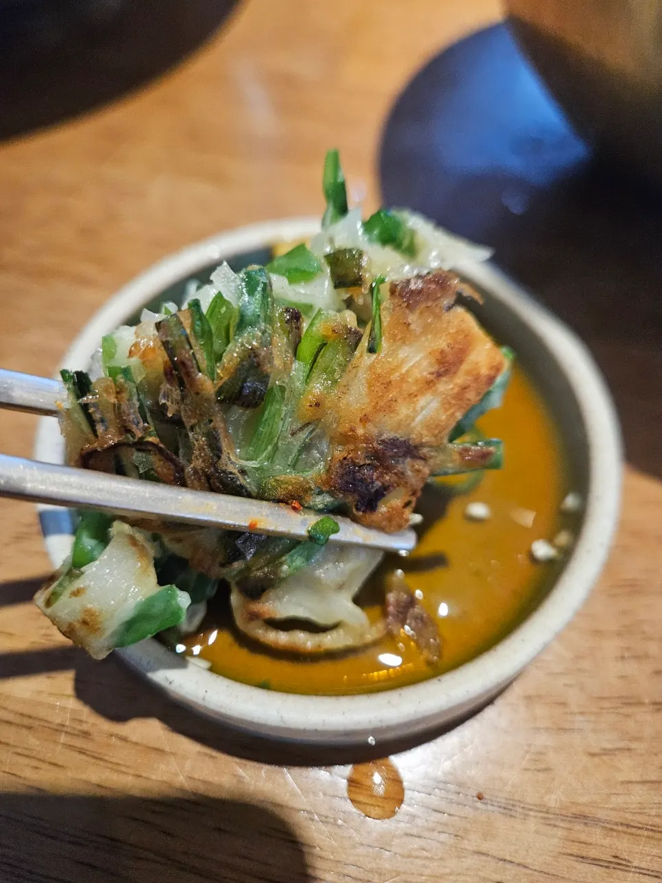 A full table with bibimbap, special gomtang, and chive pancake