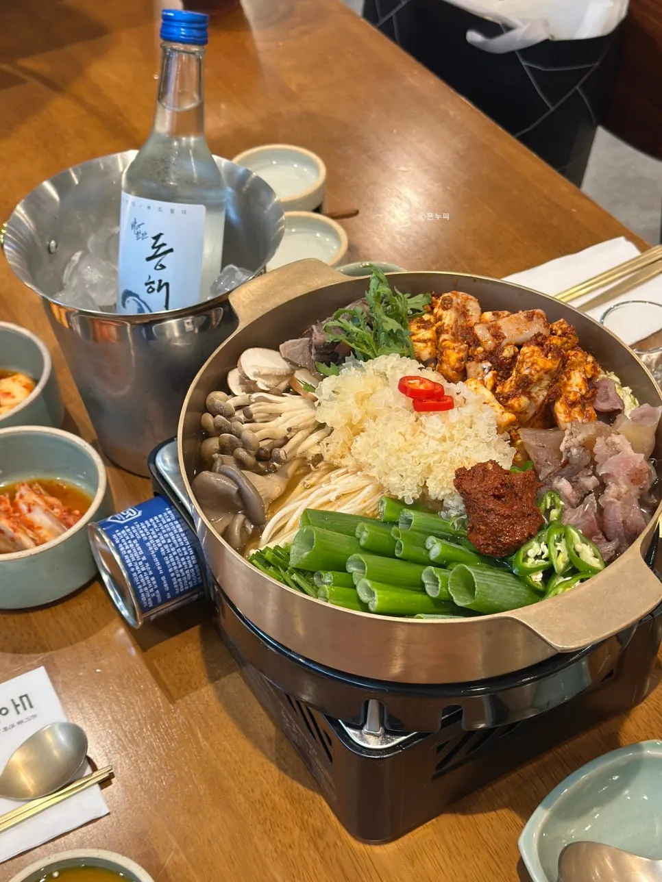 Hot pot filled with beef shank, hanwoo tripe, mushrooms, and vegetables