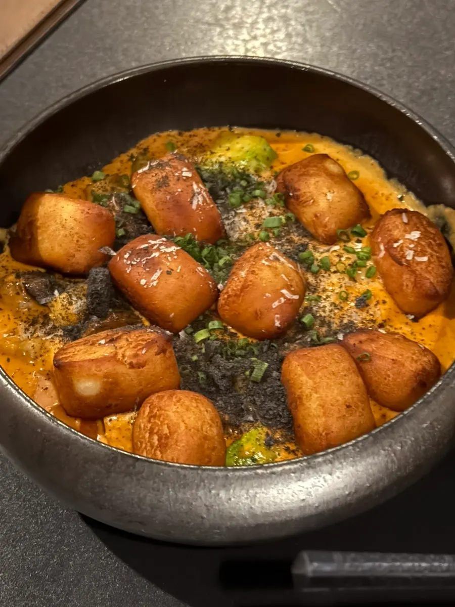 Close-up of gochujang cream gnocchi stir-fried with bacon