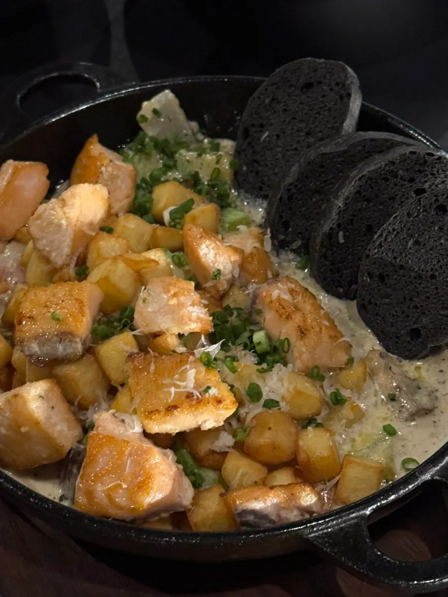 Truffle salmon cream stew served with squid ink bread