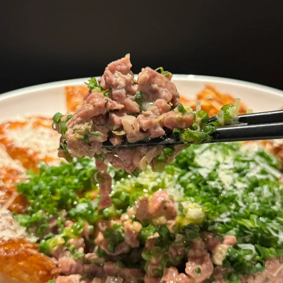 Korean beef tartare topped with egg yolk and cheese