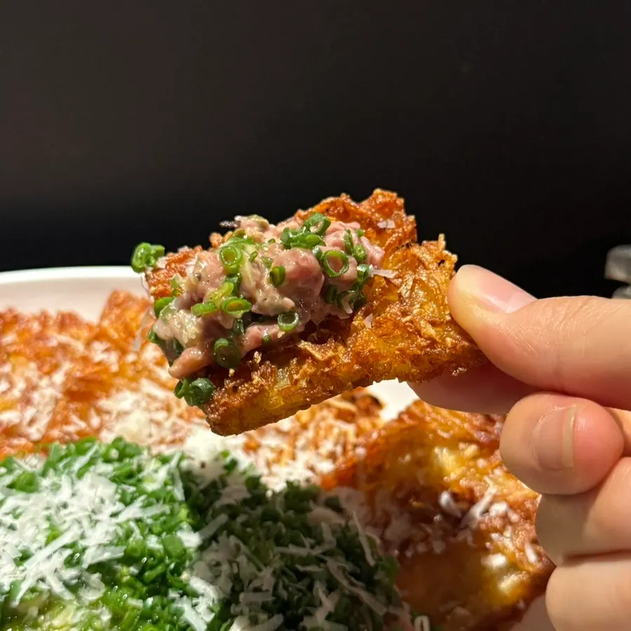 Crispy potato chips served alongside the tartare