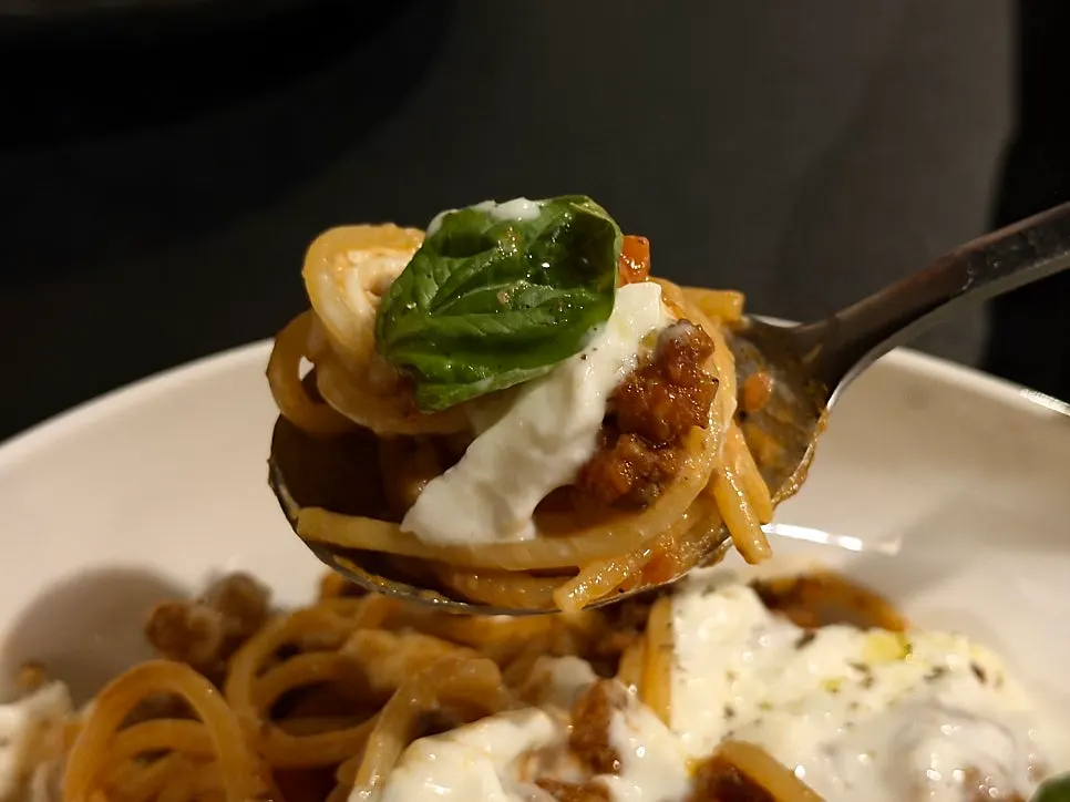 Bolognese pasta topped with cheese