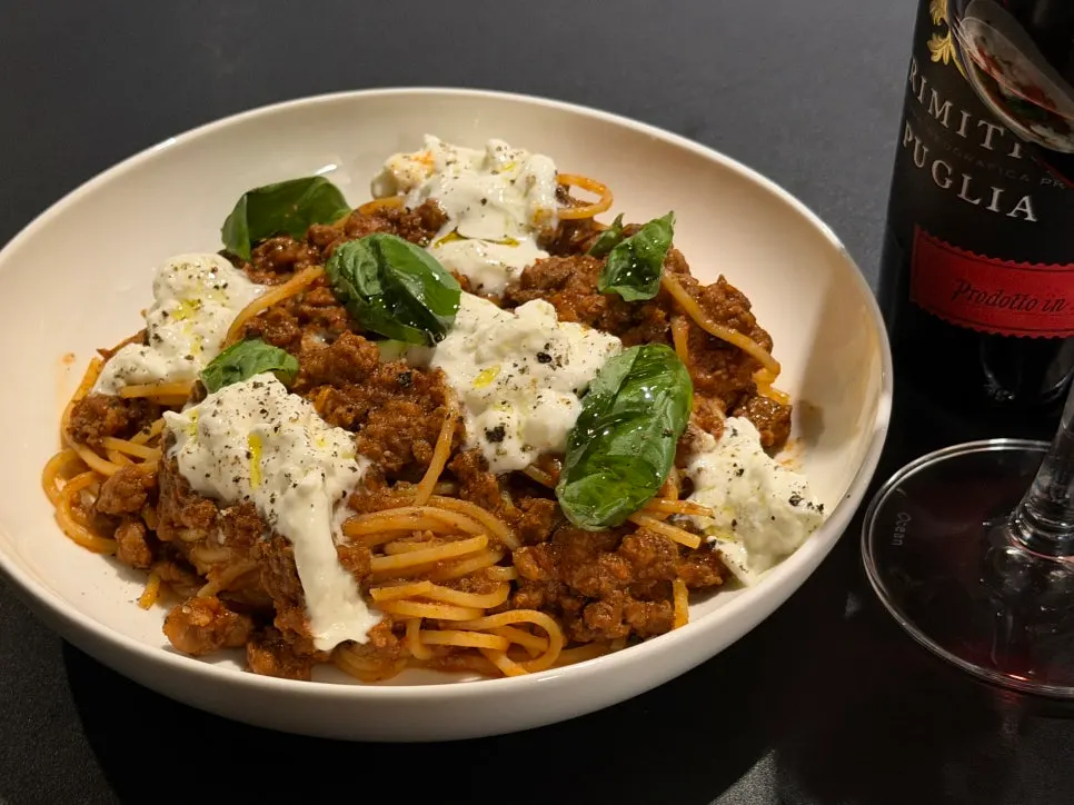 Fork lifting up bolognese pasta