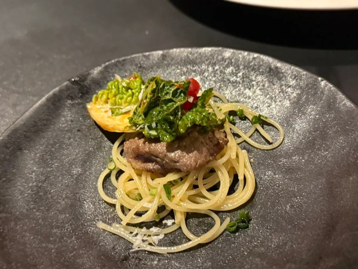 Cappellini topped with noodles, gutjeori, and meat