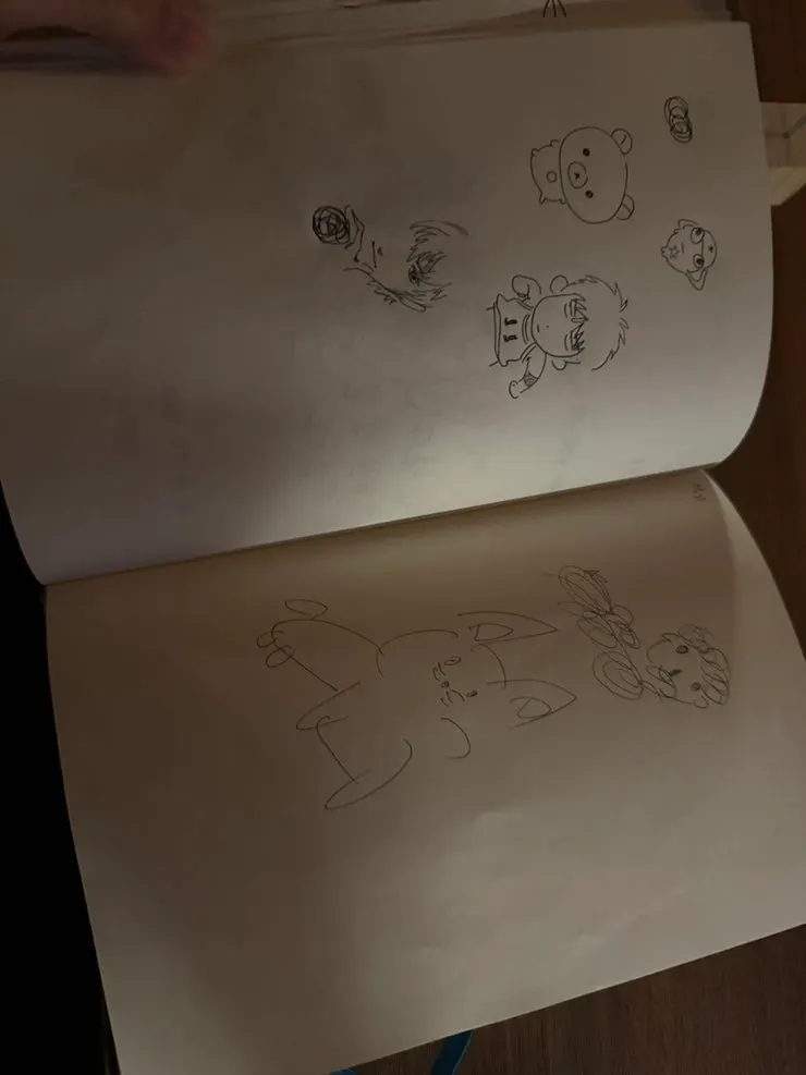 Sketchbook on the table filled with visitors' drawings