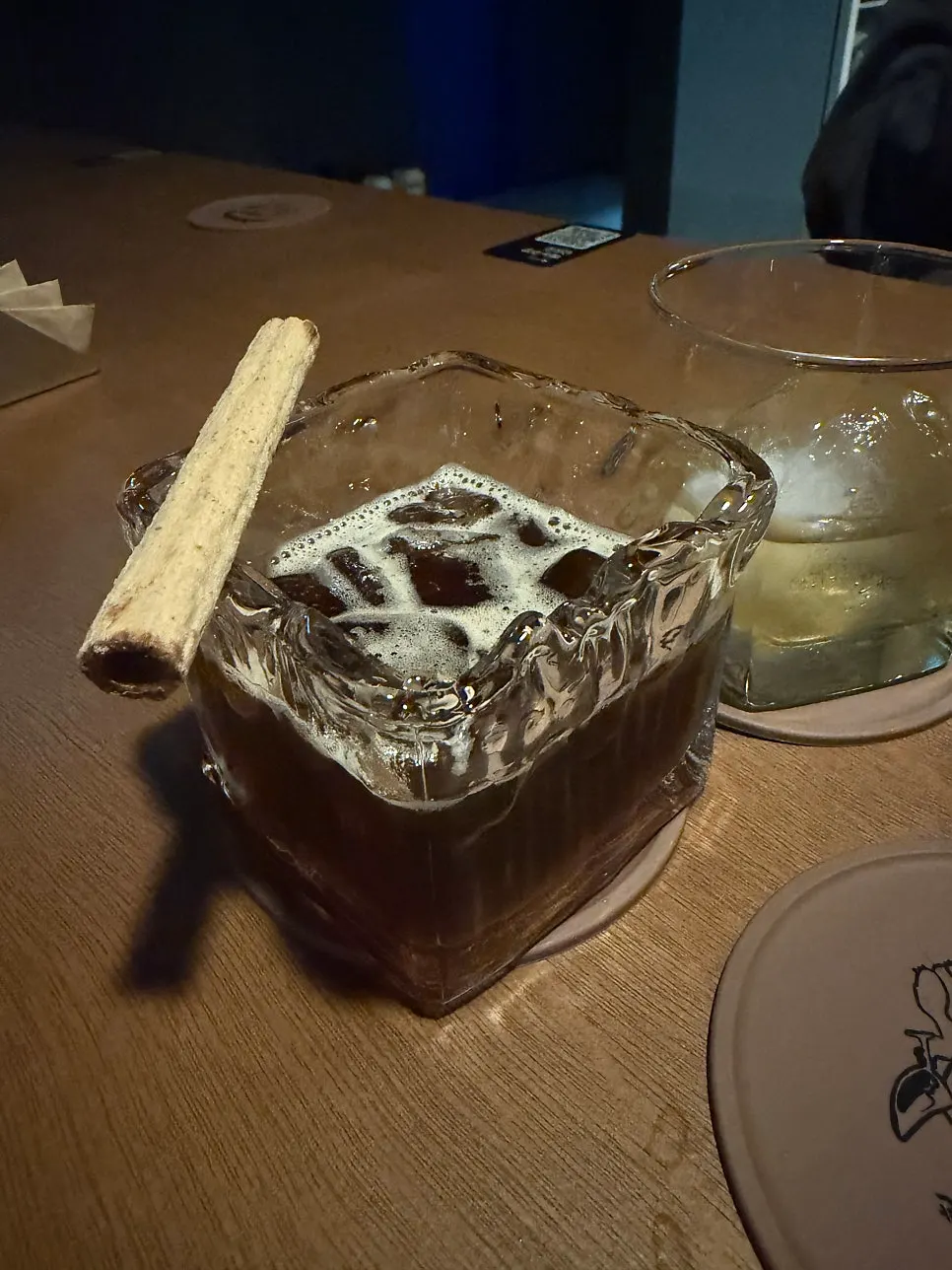 The Catharsis cocktail alongside a whiskey glass