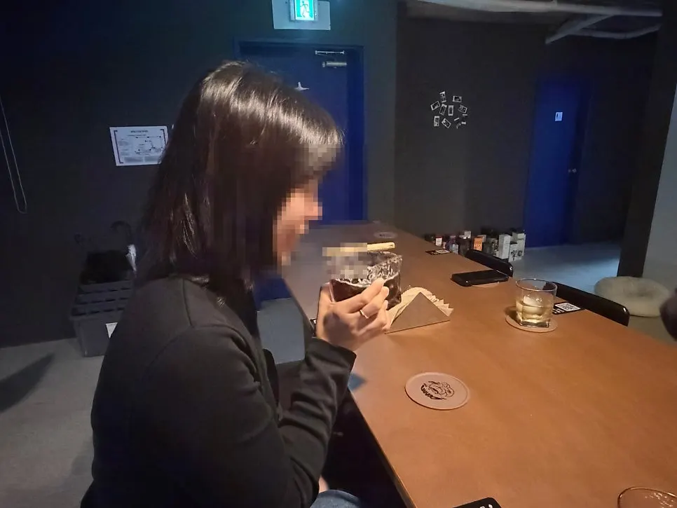A cocktail and two whiskey glasses on the table