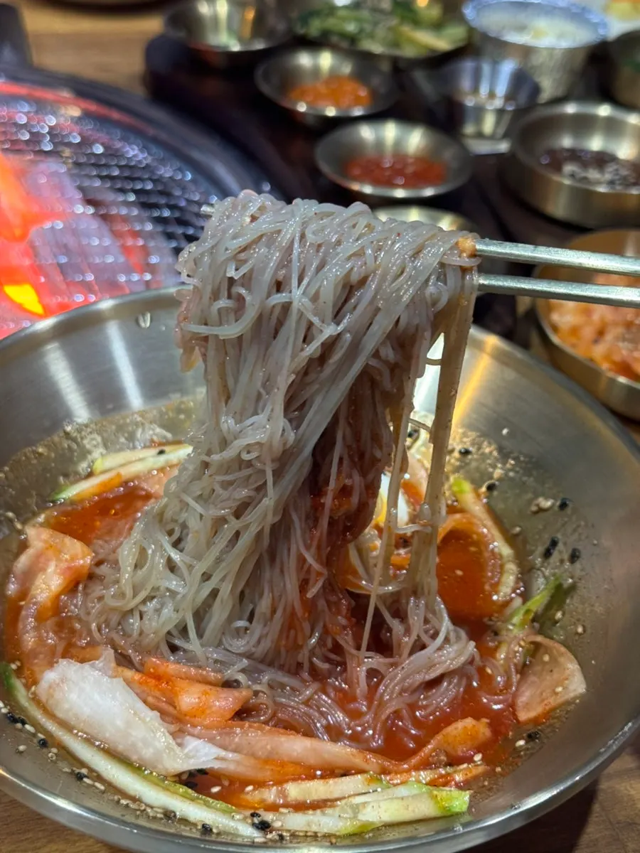 Noodles lifted with chopsticks from the bibim naengmyeon