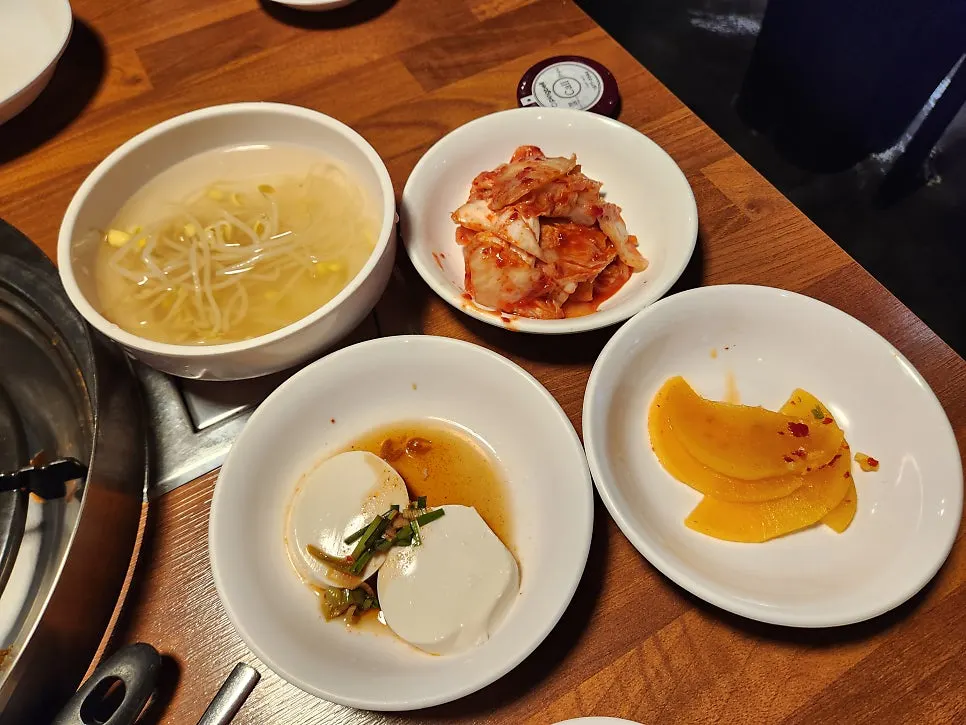 Basic side dishes: bean sprout soup, sundubu, kimchi, and pickled radish
