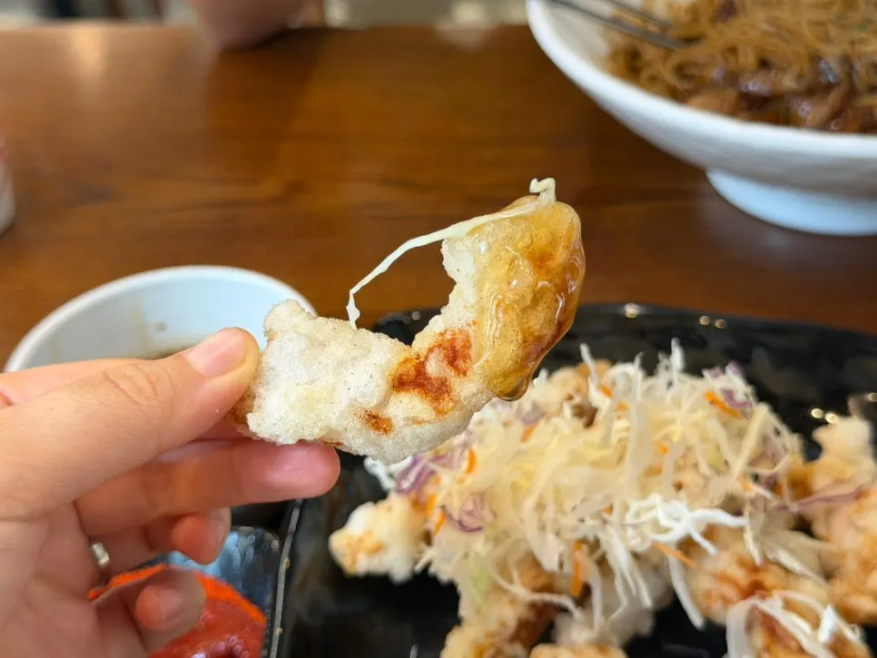 Crispy-outside, tender-inside tangsuyuk dipped in sauce