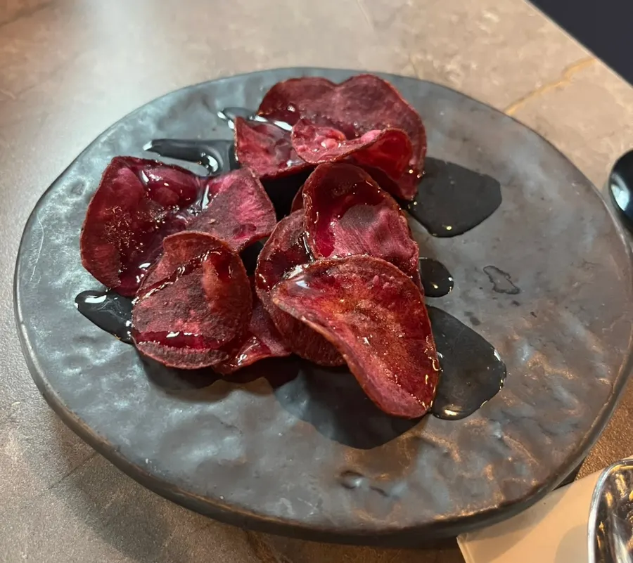 Purple sweet potato chips served as a complimentary side dish