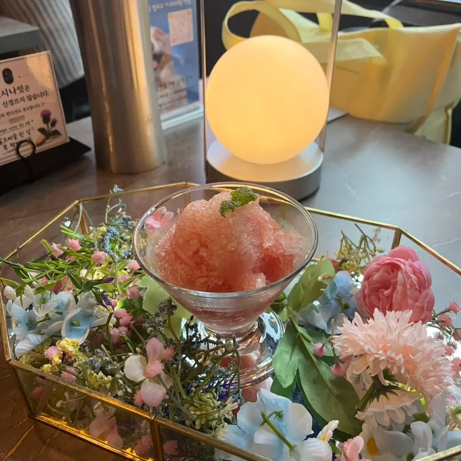 Side view of the guava sherbet topped with flower decoration