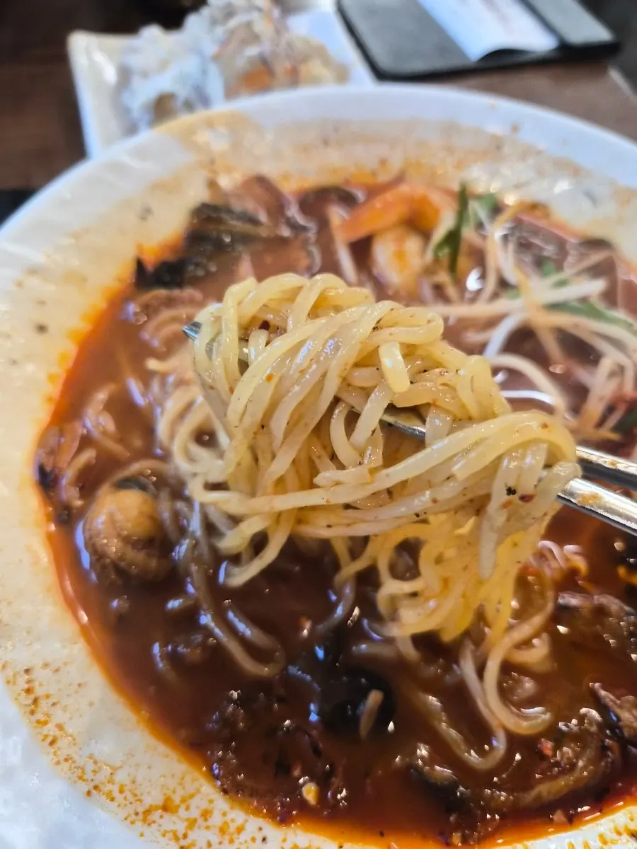 Close-up of the hot pepper jjamppong broth and ingredients