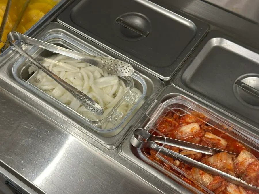 Danmuji, onion, and kimchi at the self-serve bar