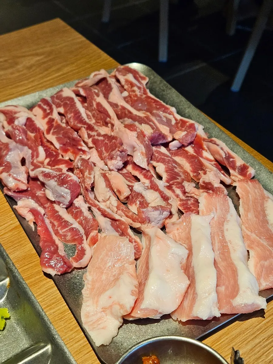 Plate of ordered raw pork specialty cuts