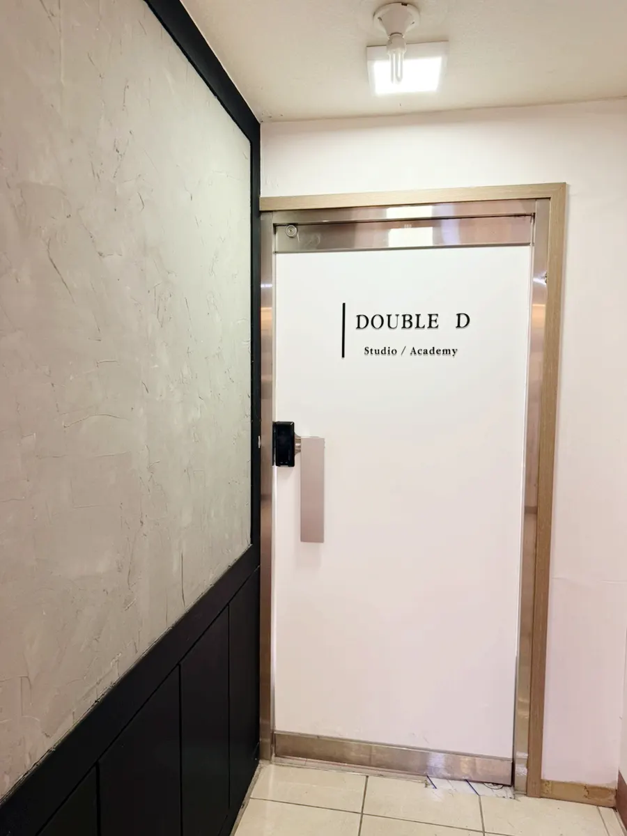 Entrance door reading DOUBLE D at the end of the hallway