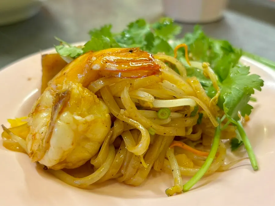 Close-up of seafood pad thai showing large shrimp