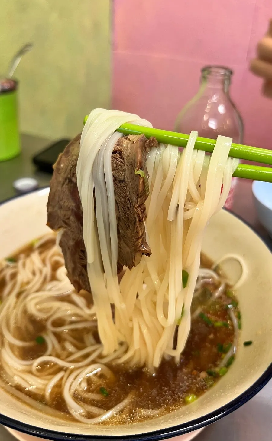 Close-up of the rich, dark beef pho broth