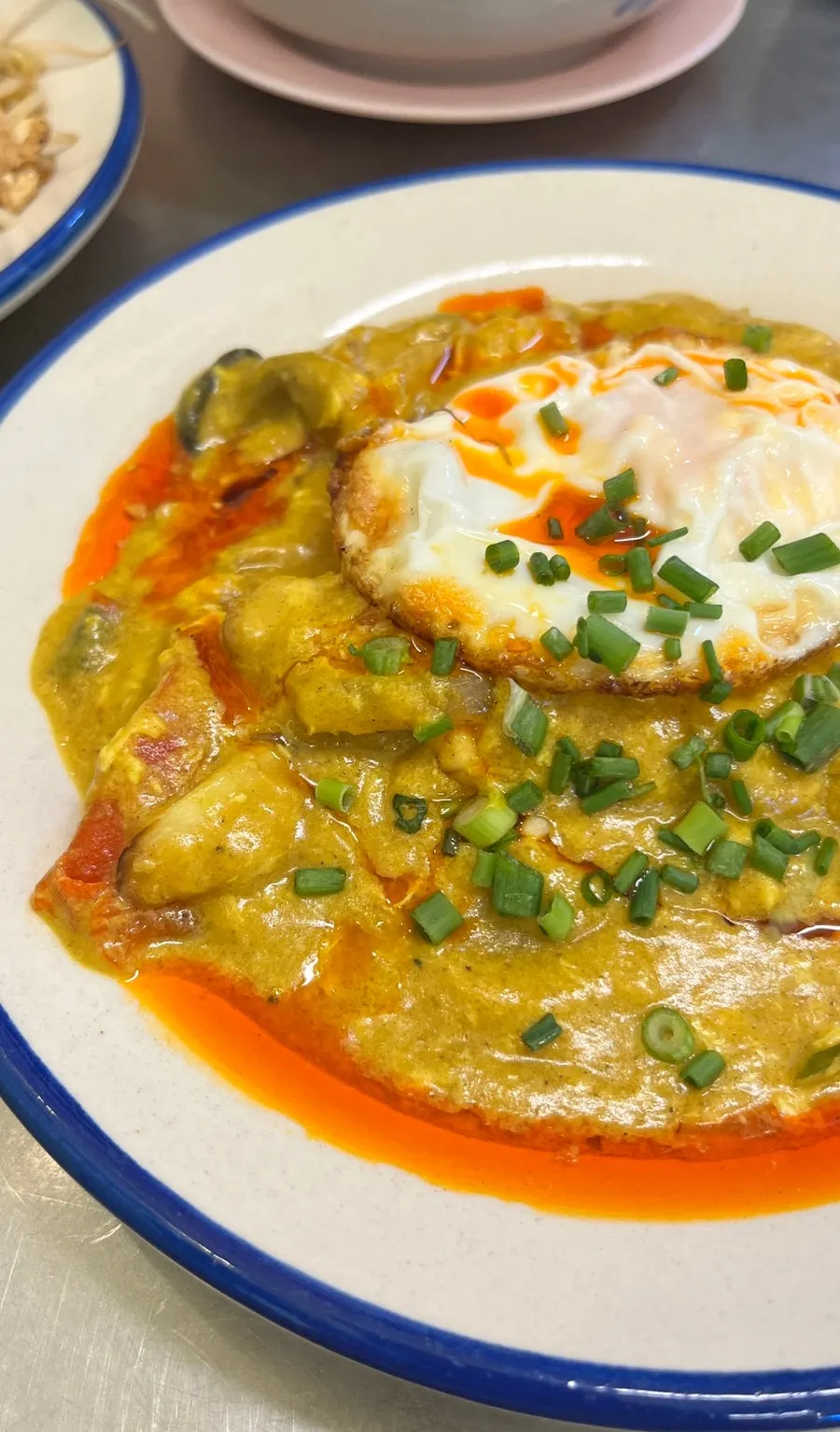 Poo pad pong curry topped with a fried egg