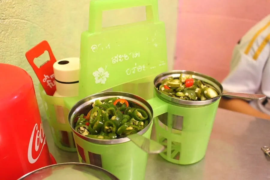 Table set with four ordered Thai dishes
