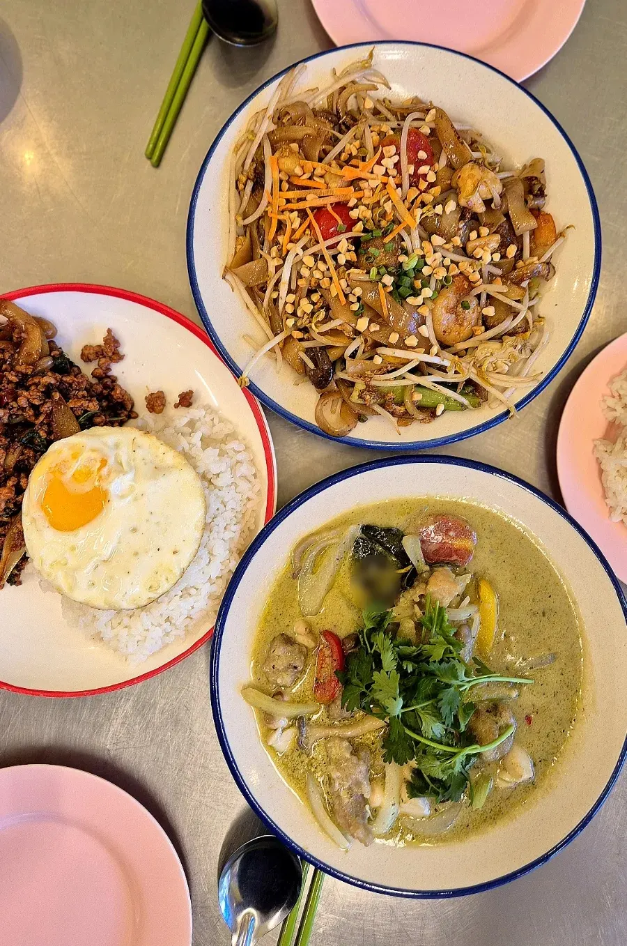 Pad see ew, pad kaprao moo sap, and green curry served together