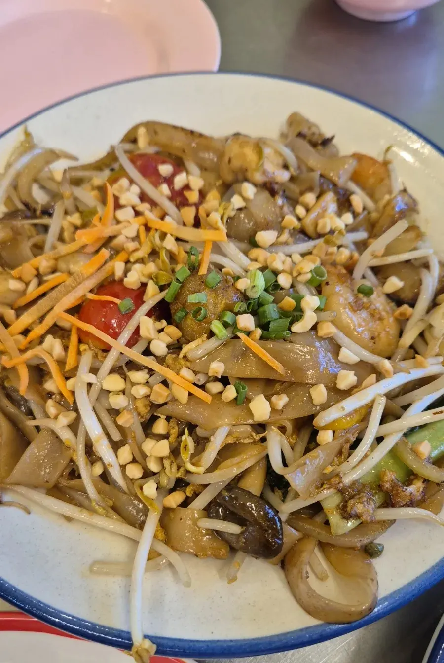 Close-up of sauce-soaked pad see ew stir-fried noodles