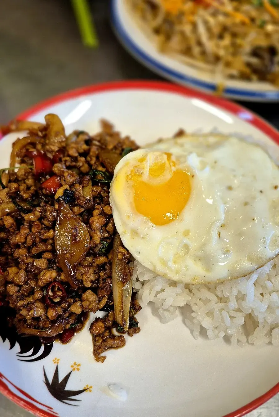 Pad kaprao moo sap served with rice and a fried egg