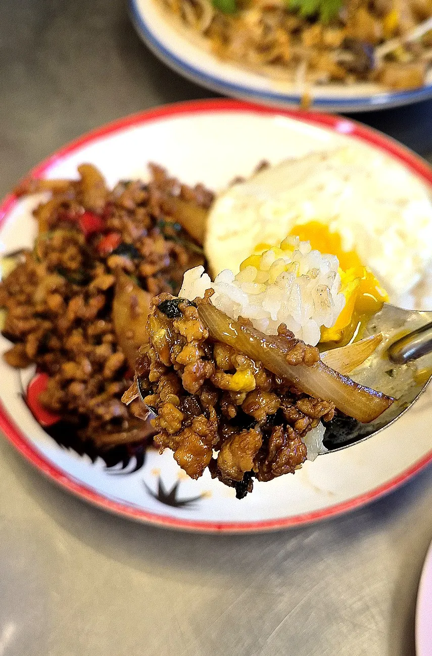 Fried egg yolk on pad kaprao moo sap