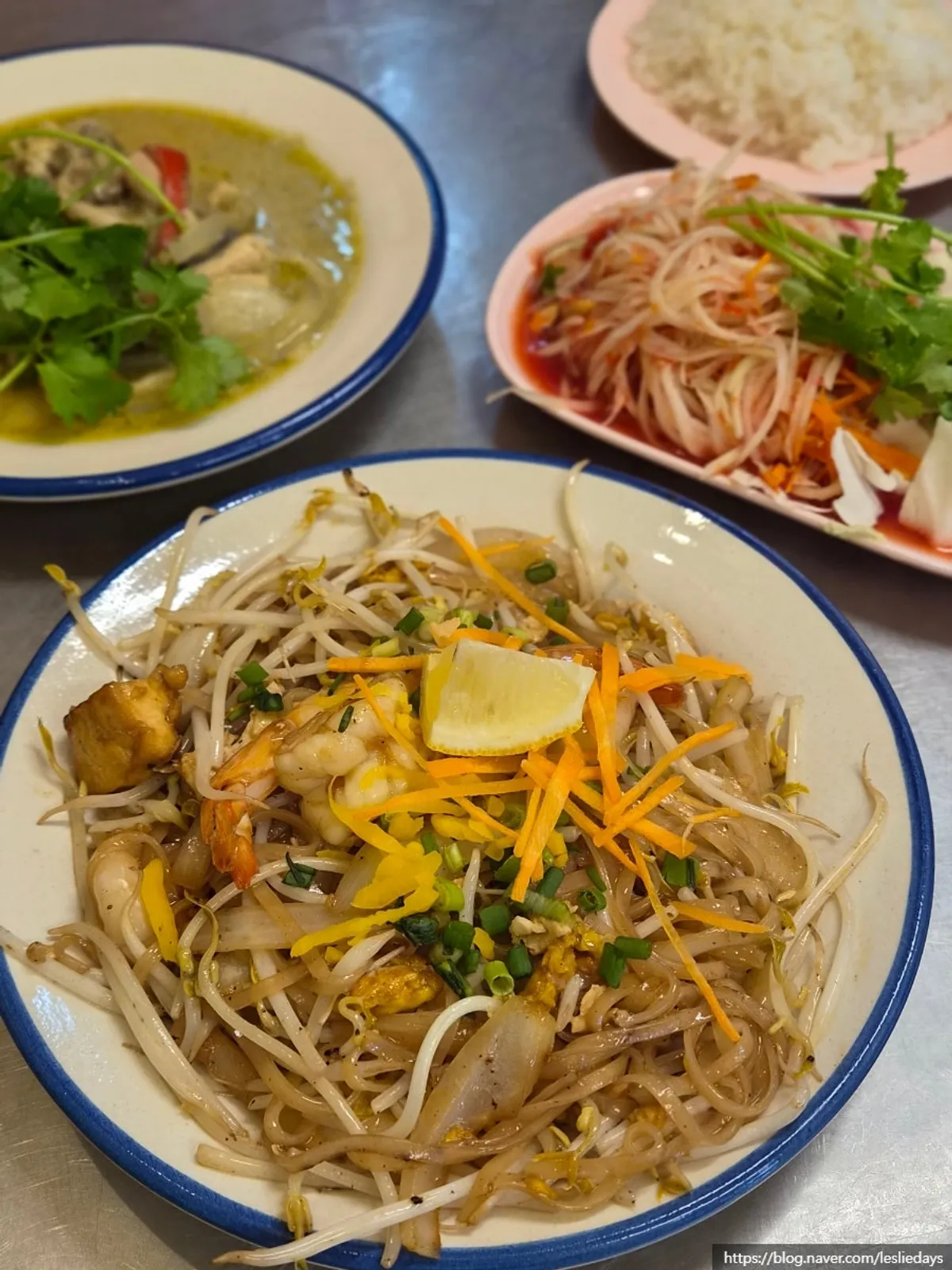 Pad thai topped with shrimp and bean sprouts