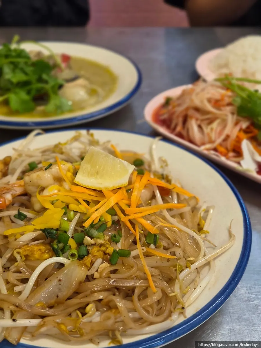 A bite of pad thai sprinkled with peanut powder